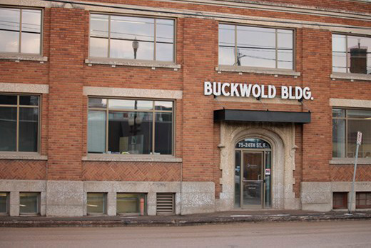 The front of the Buckwold Building with large windows and a central arched entrance.